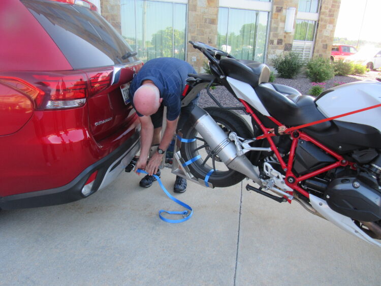 MoTow Motorcycle Tow Hitch Safety Strap being installed on motorcycle and vehicle